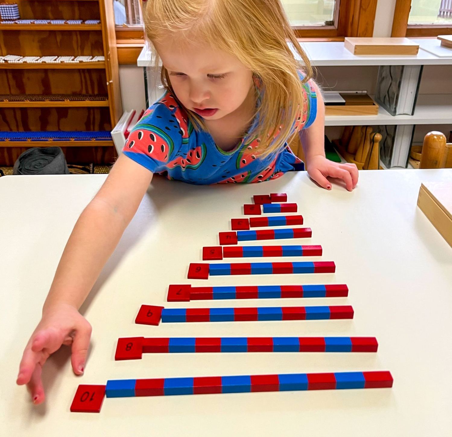 Child working with Montessori math materials