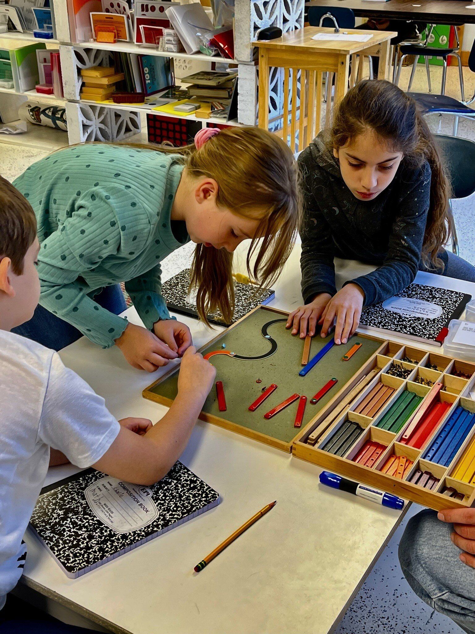 Montessori children working together in the classroom