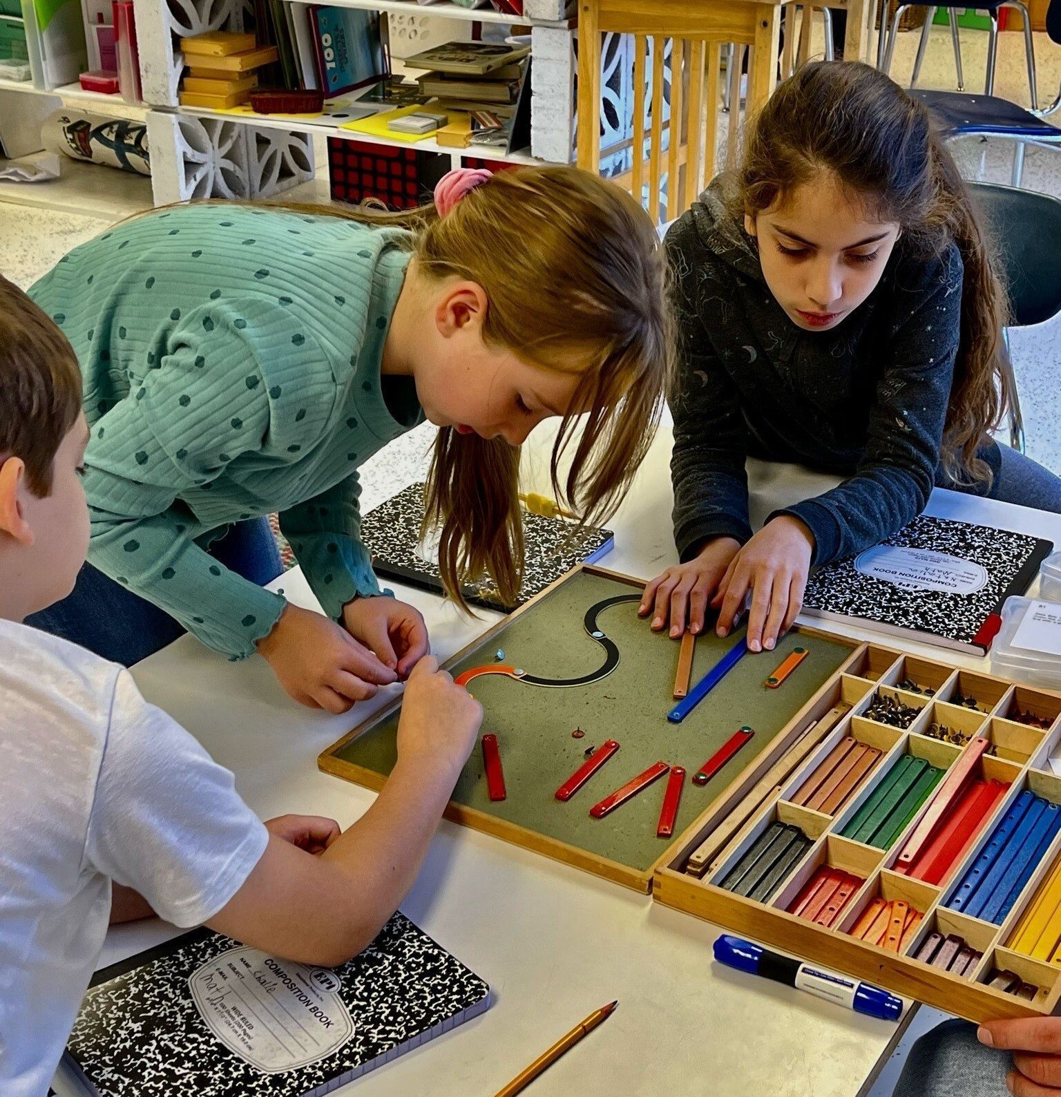 Montessori children working together in the classroom