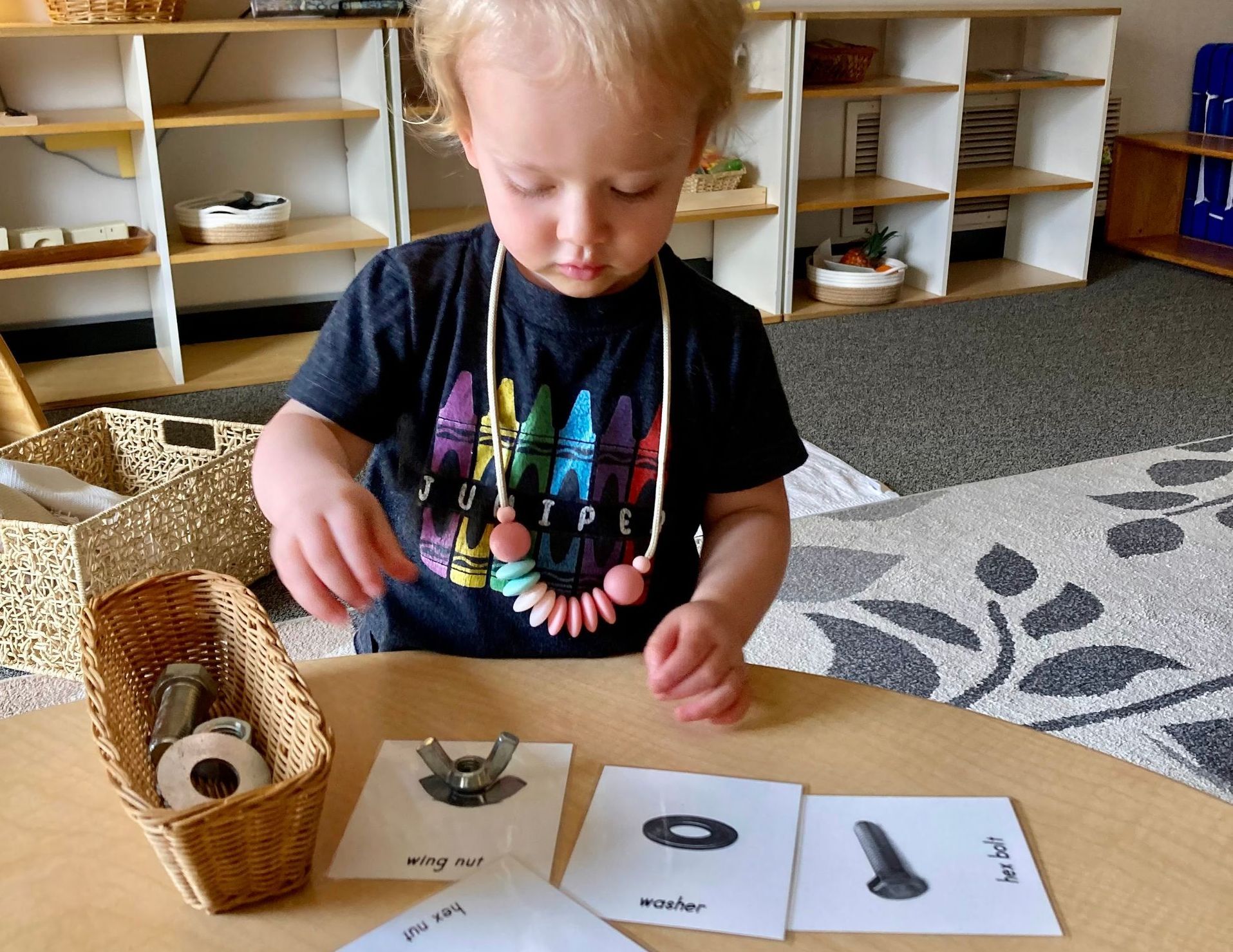 Montessori child working with the Knobbed Cylinders Material