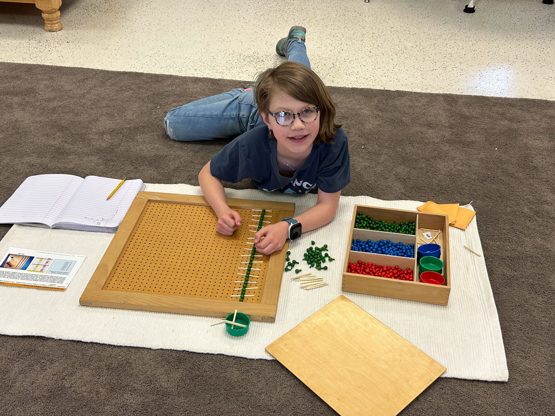 Montessori child working with math materials 