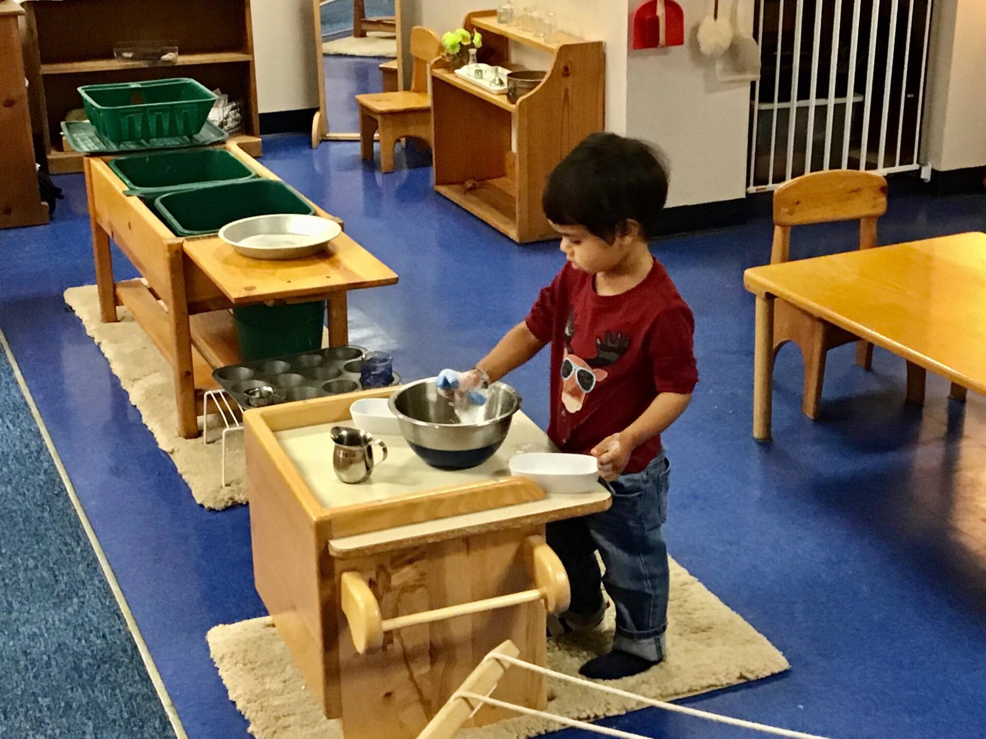 Montessori toddler working on practical life skills