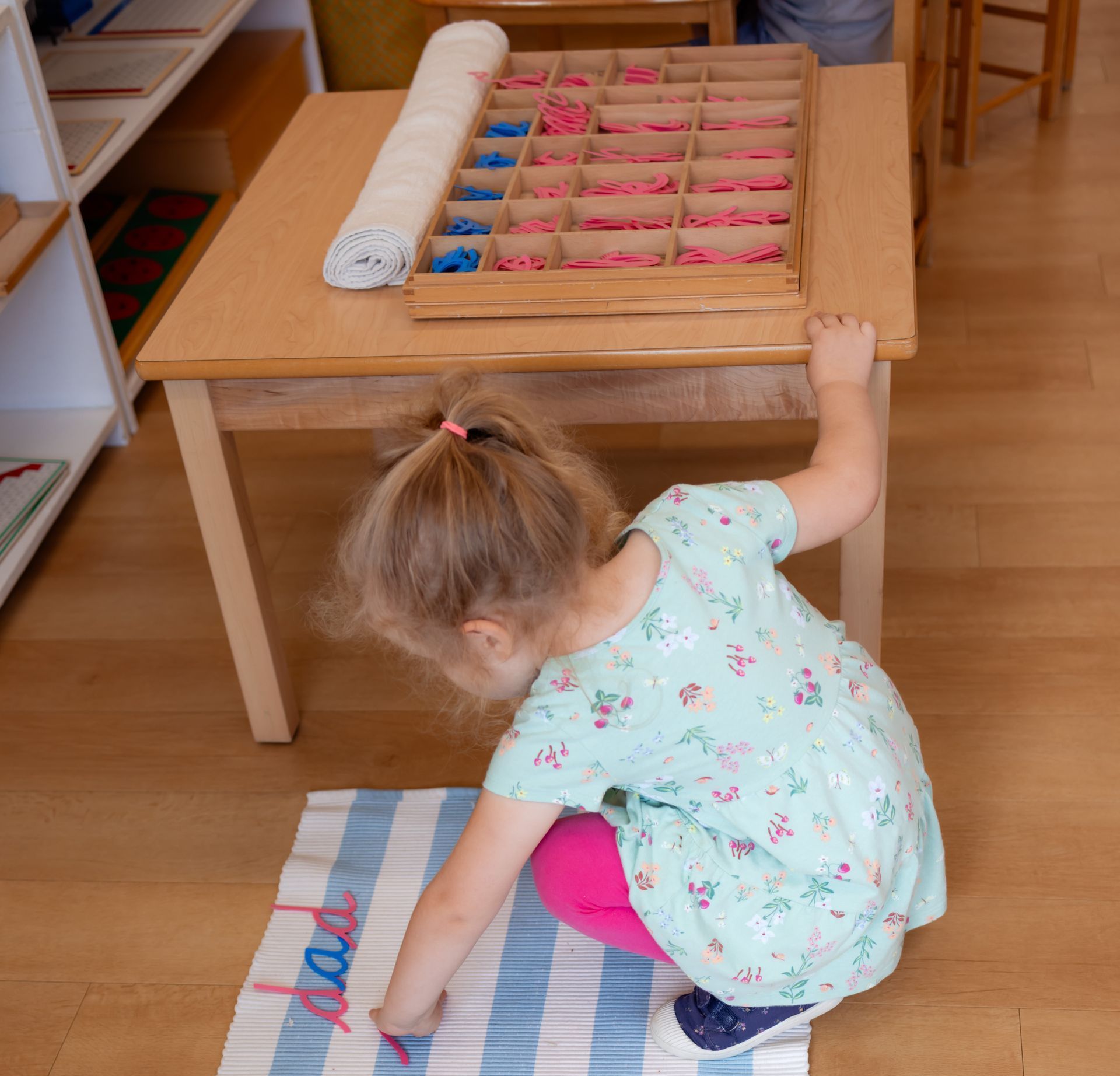 Montessori child working with language materials