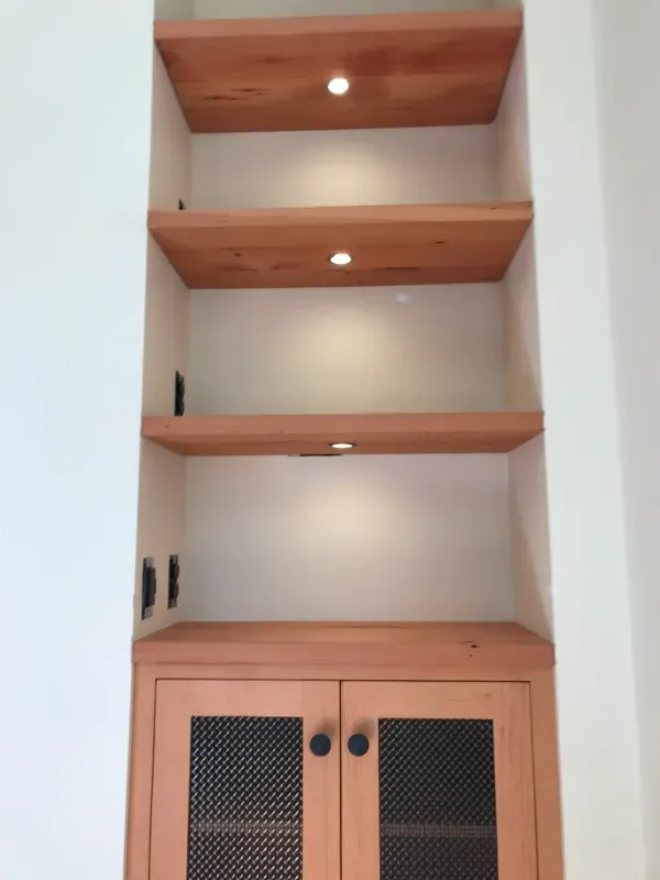 A wooden shelf with a cabinet underneath it
