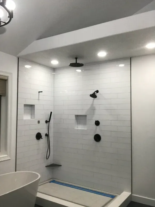 A bathroom with a walk in shower and a bathtub.