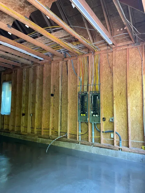 A garage with a lot of wires hanging from the ceiling.