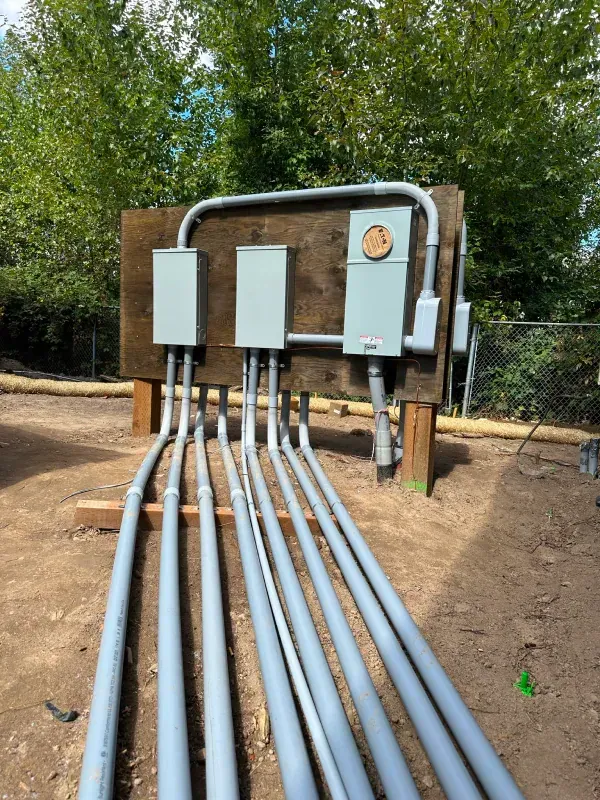 A bunch of electrical wires are connected to a wooden wall.