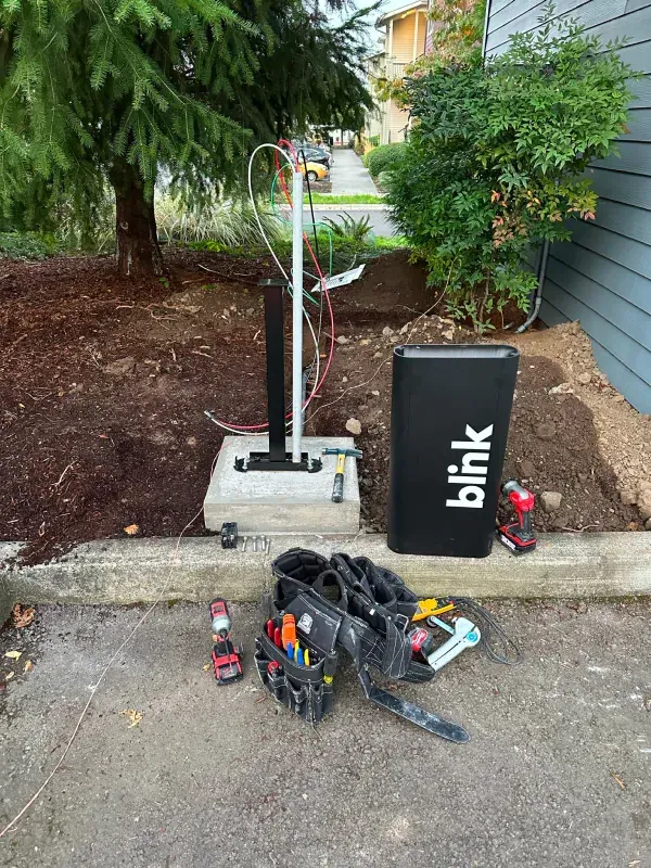 A blink box is sitting on the side of the road next to a toolbox.