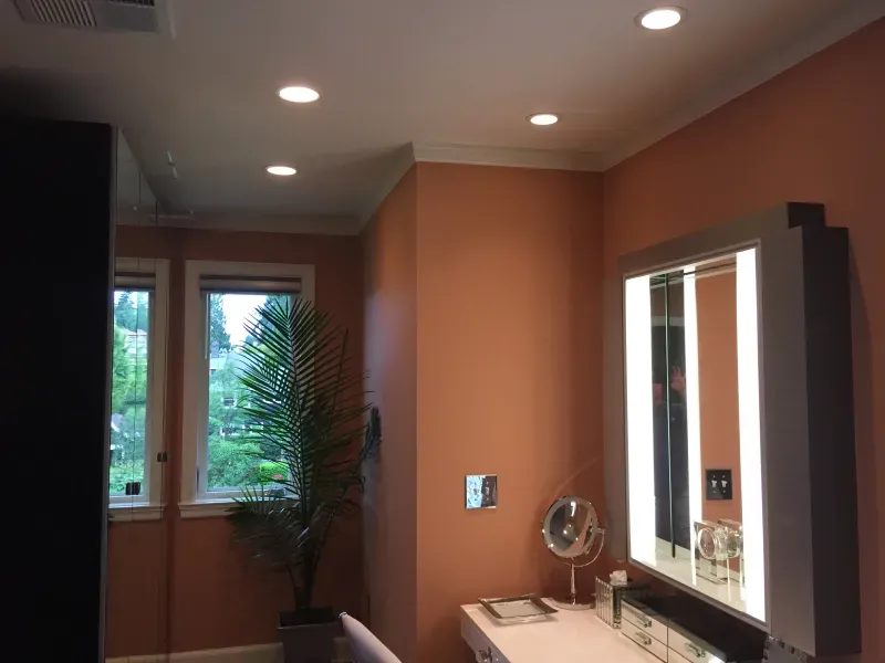 A bathroom with two mirrors and a vanity.