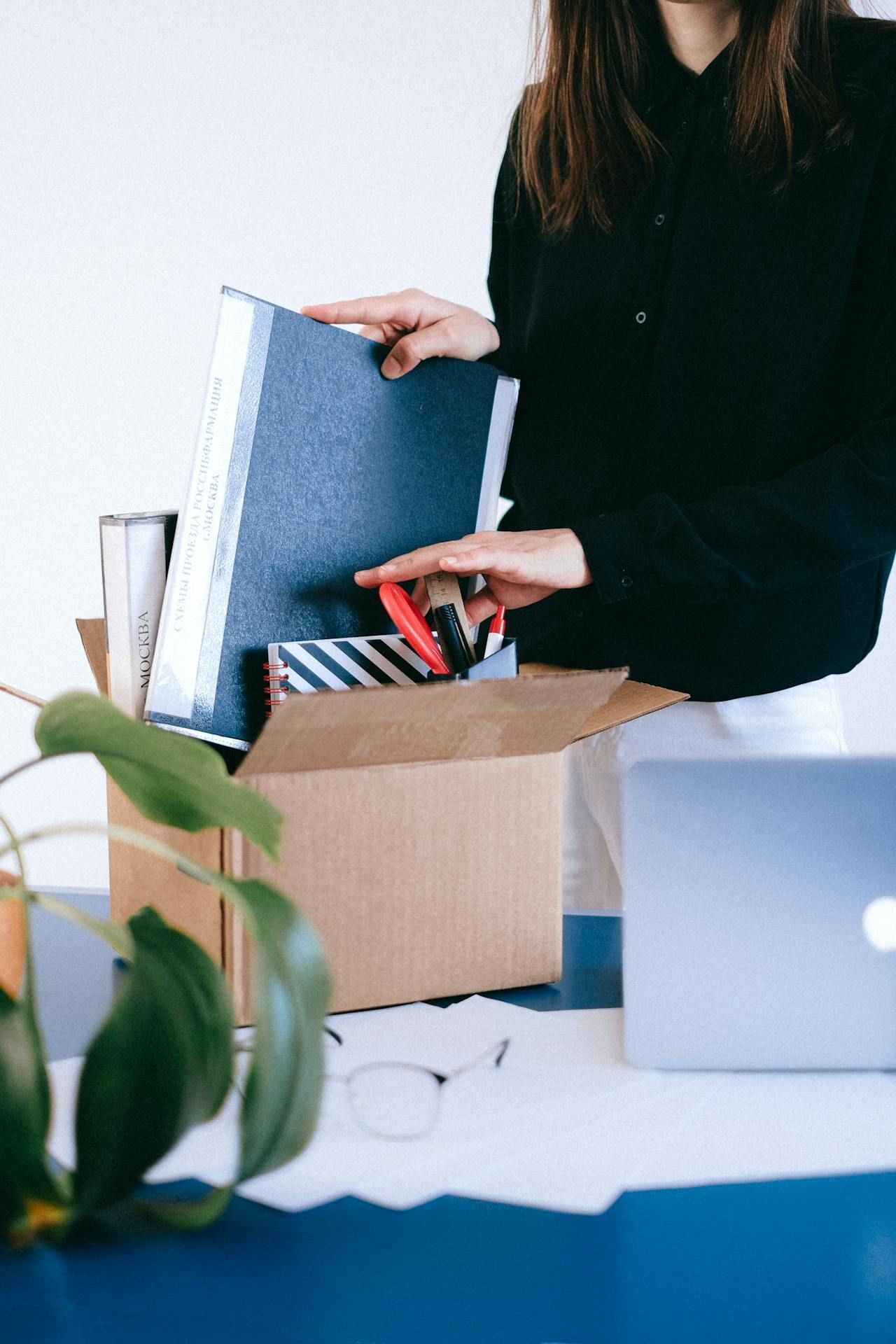 Unpacking office supplies, symbolizing a transition from corporate life to franchise ownership.