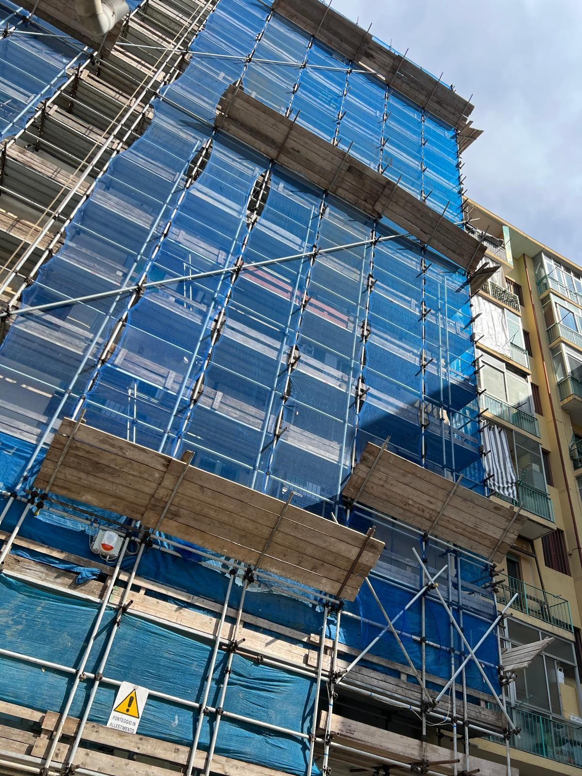 Un edificio in costruzione con impalcature ai lati.