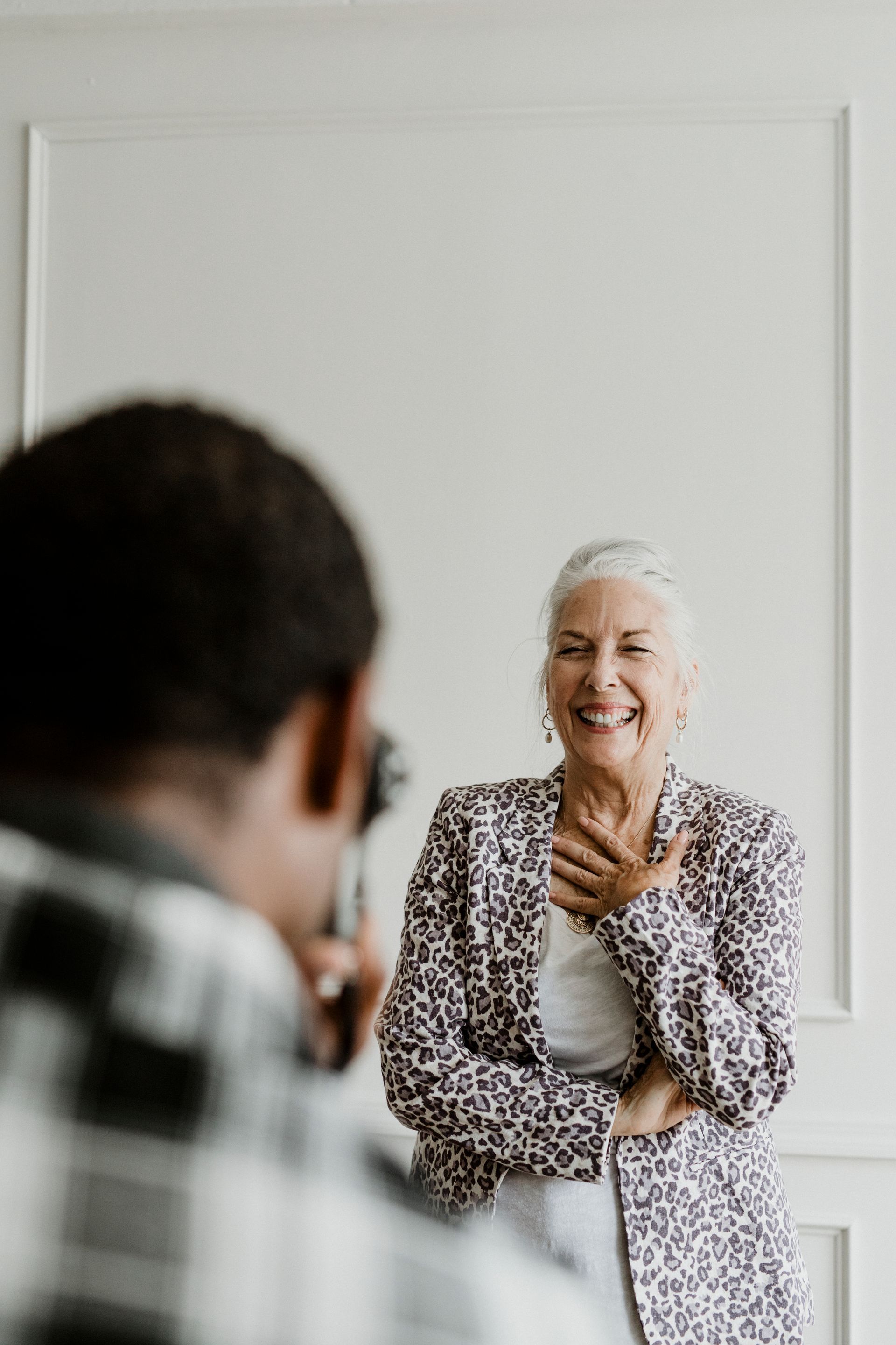A man is taking a picture of an older woman.