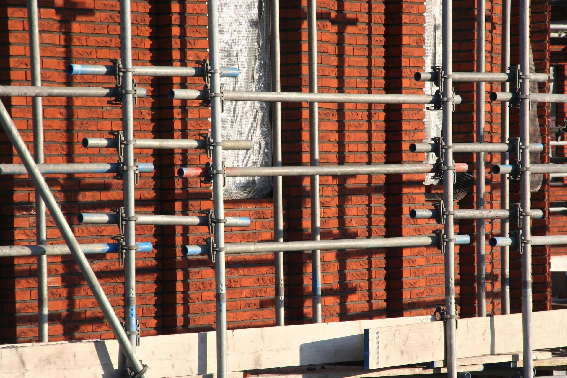 a brick wall with scaffolding around it