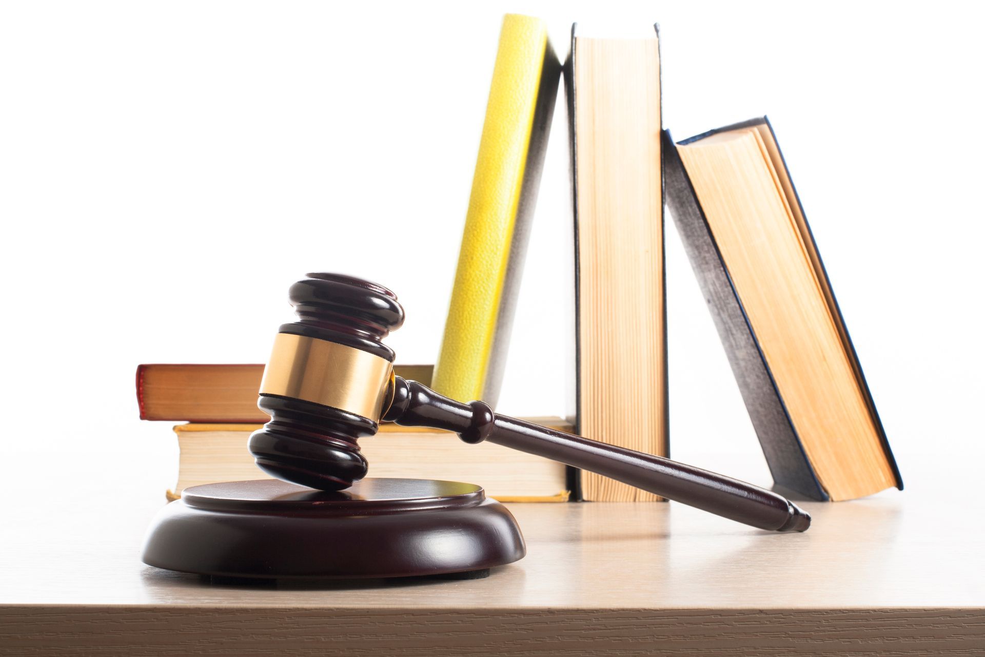 Book with wooden gavel on table, showcasing a family lawyer in legal practice and court cases.