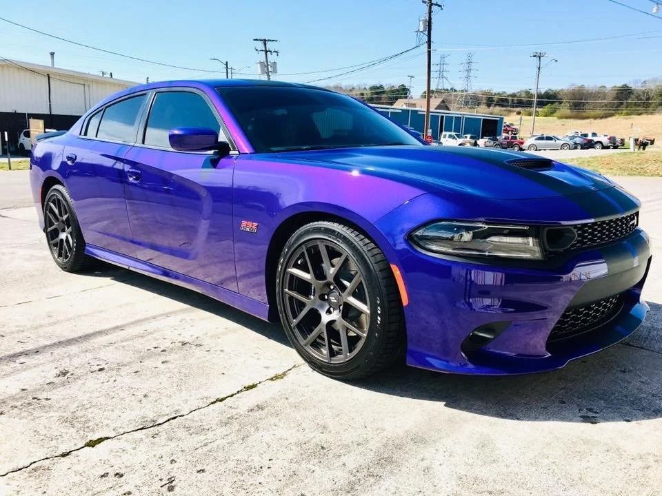 Blue Dodge Charger parked outside.