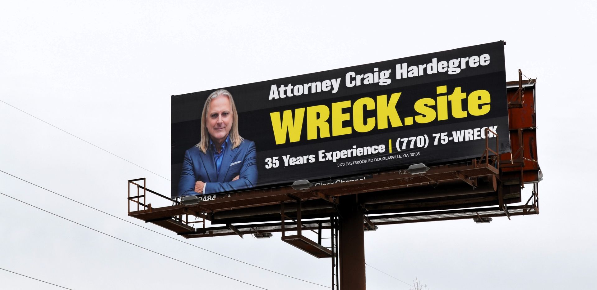 A billboard for attorney Craig Harddegree featuring his photo and the website WRECK.site with a phone number.