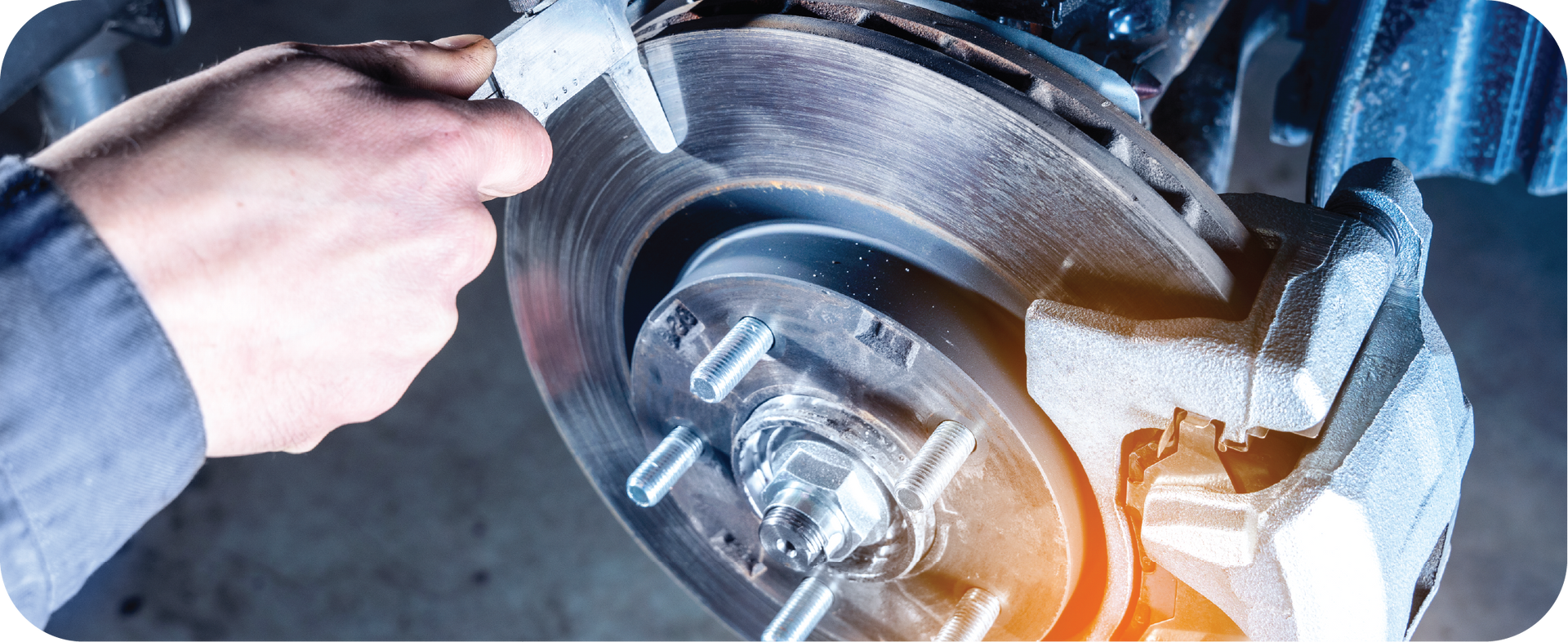 A person is working on a brake disc on a car.