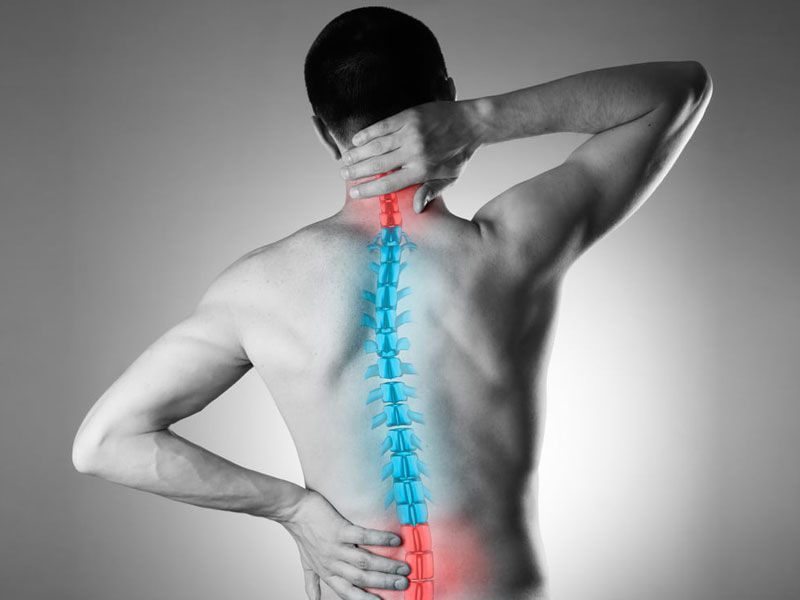 Man's spine with chronic pain points.