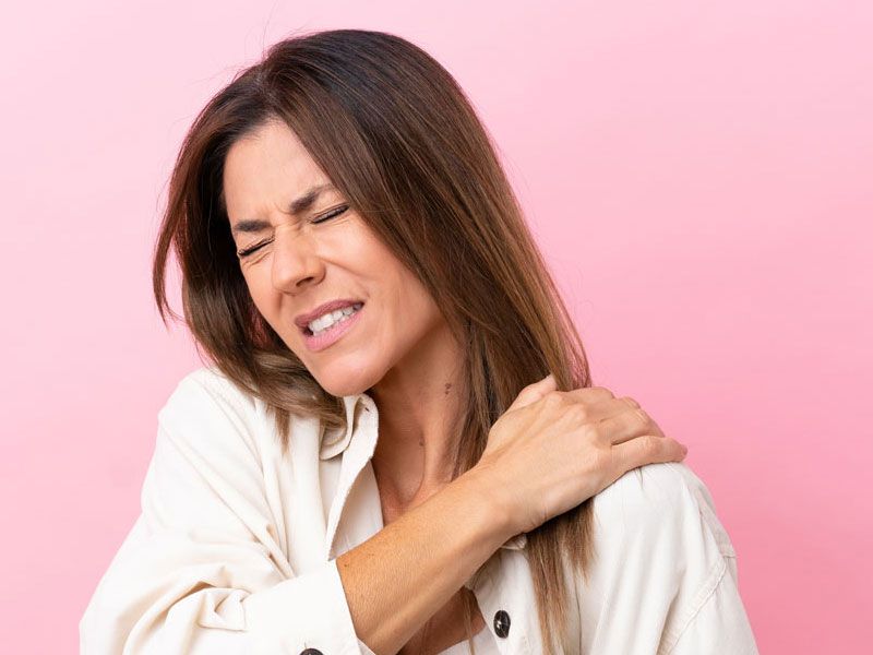 Woman suffering with a stiff neck.