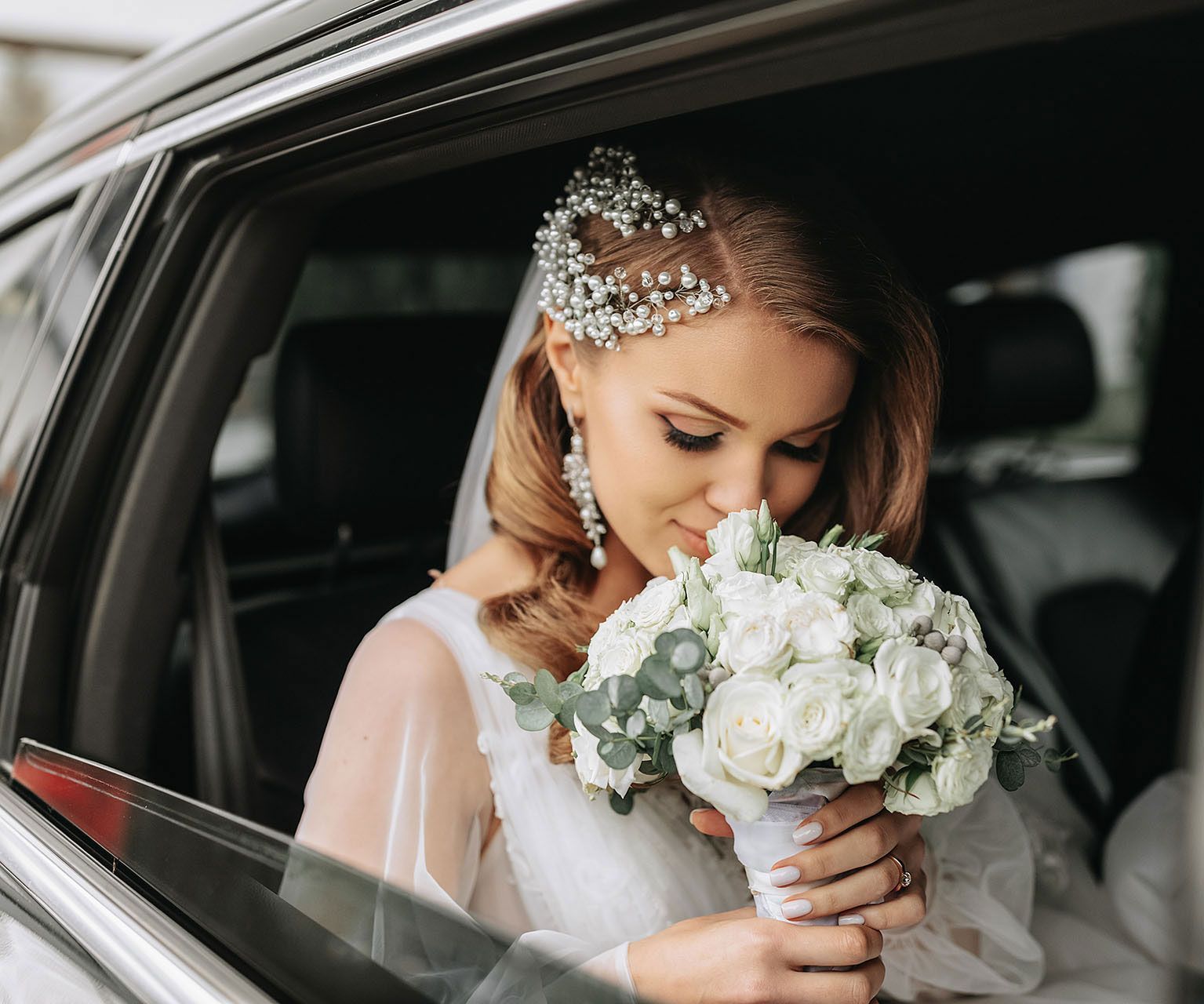 Silhouetted couple holding hands, facing each other against a cloudy sky.