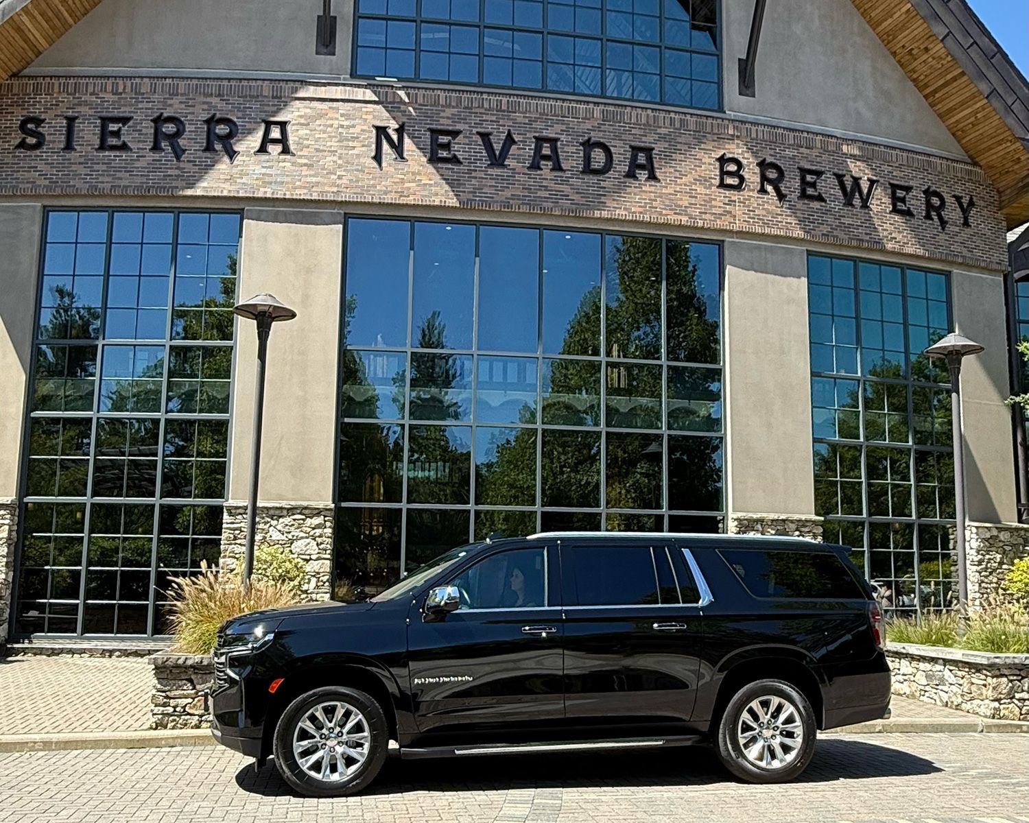 Black Luxury Suburban SUV parked in front of the Sierra Nevada Brewery.