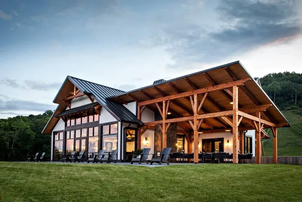 Stone Ashe Vineyard's timber-framed covered patio and glass-walled tasting room overlooking the vineyard grounds.