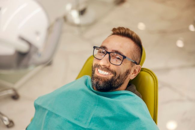 A man smiling in dental chair