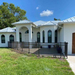 White House with Black Fence — Naples, FL — Classified Fence and Gate