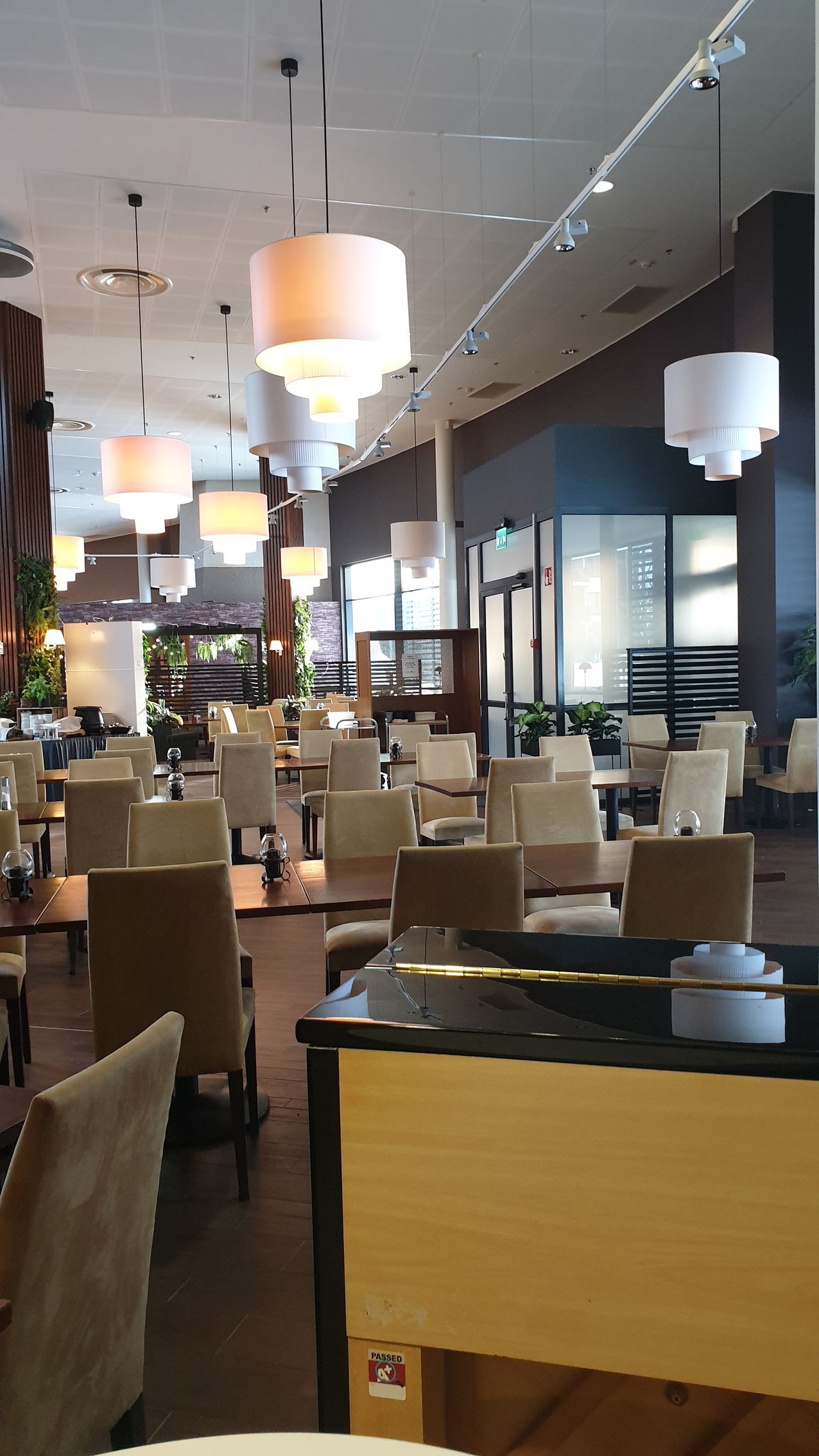 A restaurant with tables and chairs and a piano in the middle