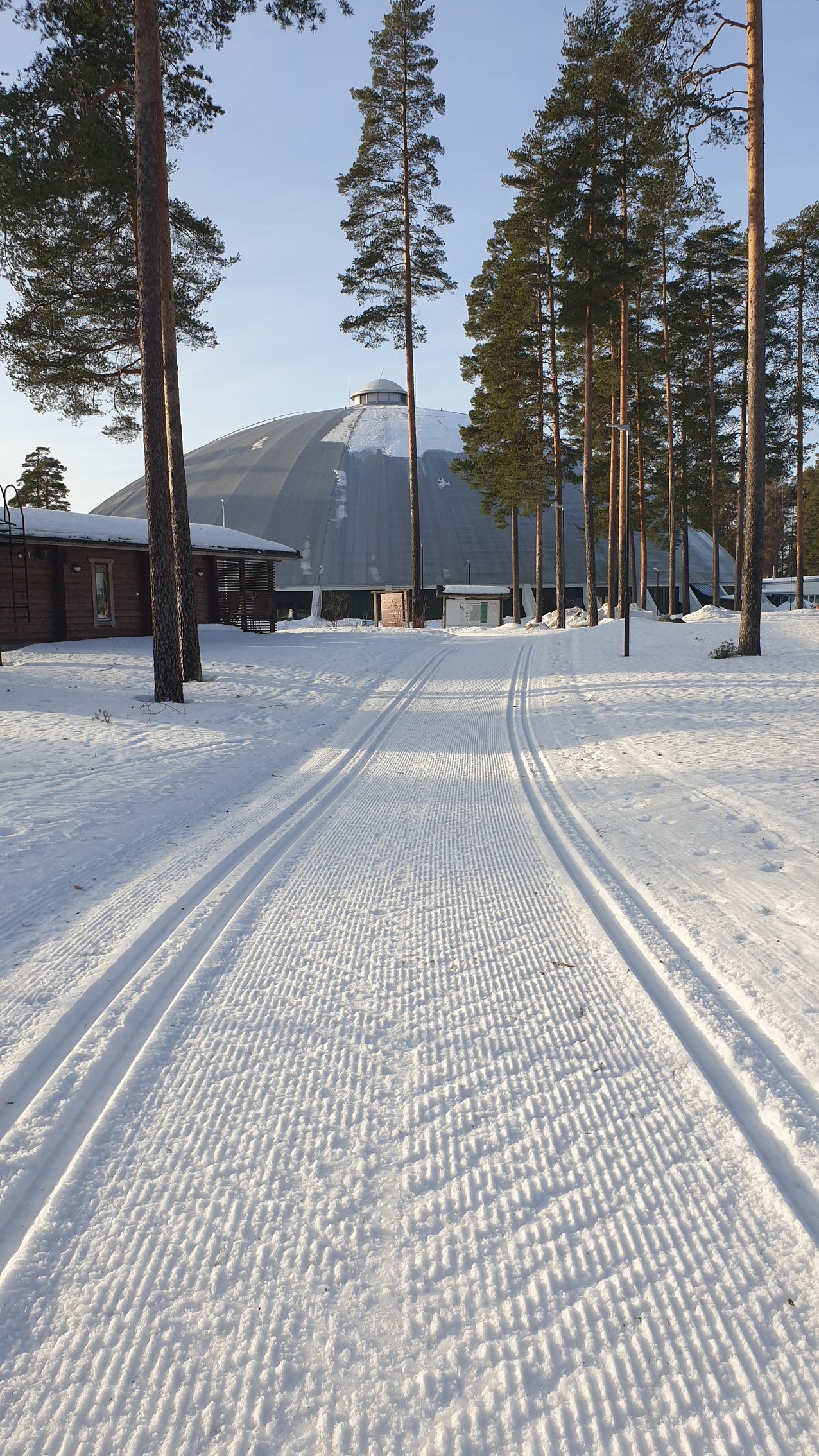 A snowy road with a mountain in the background