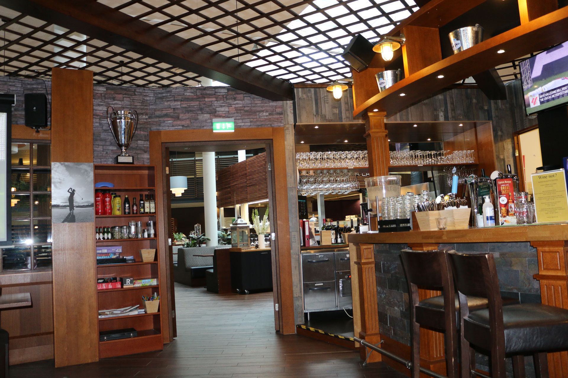 The inside of a restaurant with a bar and stools