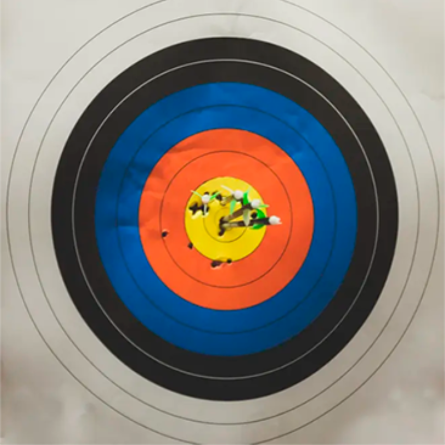 A close up of a target with arrows in it