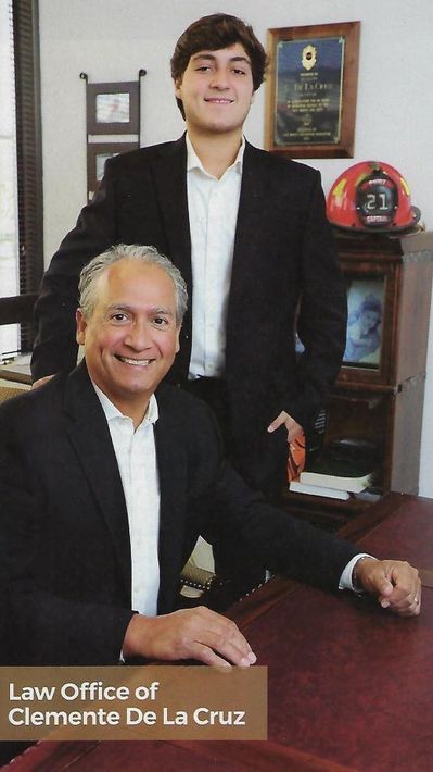 Two men are standing next to each other in the law office of clemente de la cruz