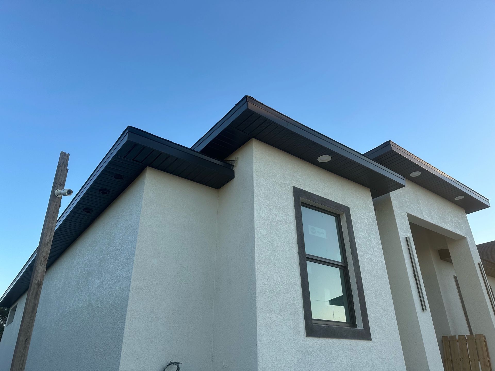 A white house with a window and a blue sky in the background