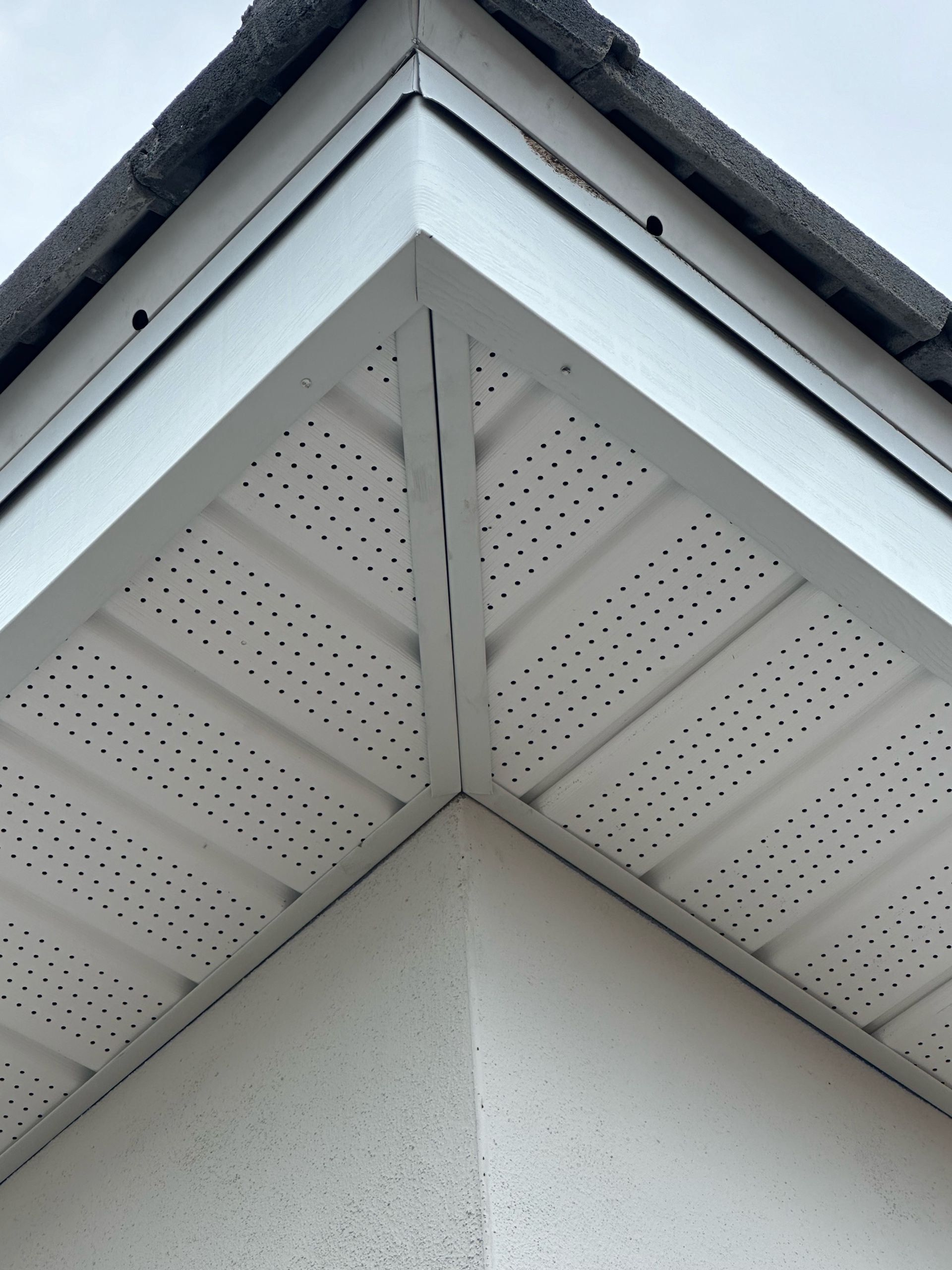 A close up of a white roof with holes in it