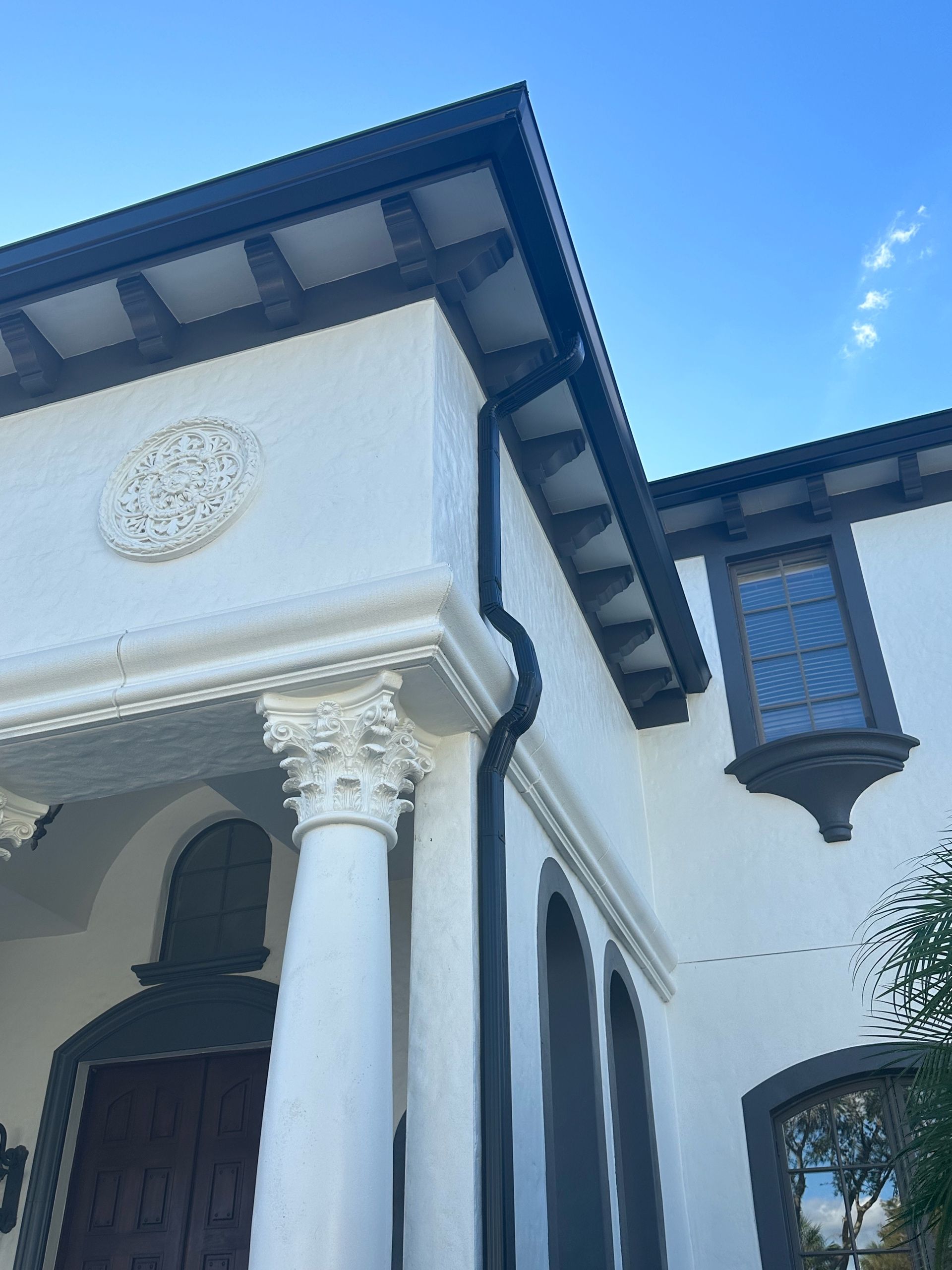 The front of a white house with columns and windows