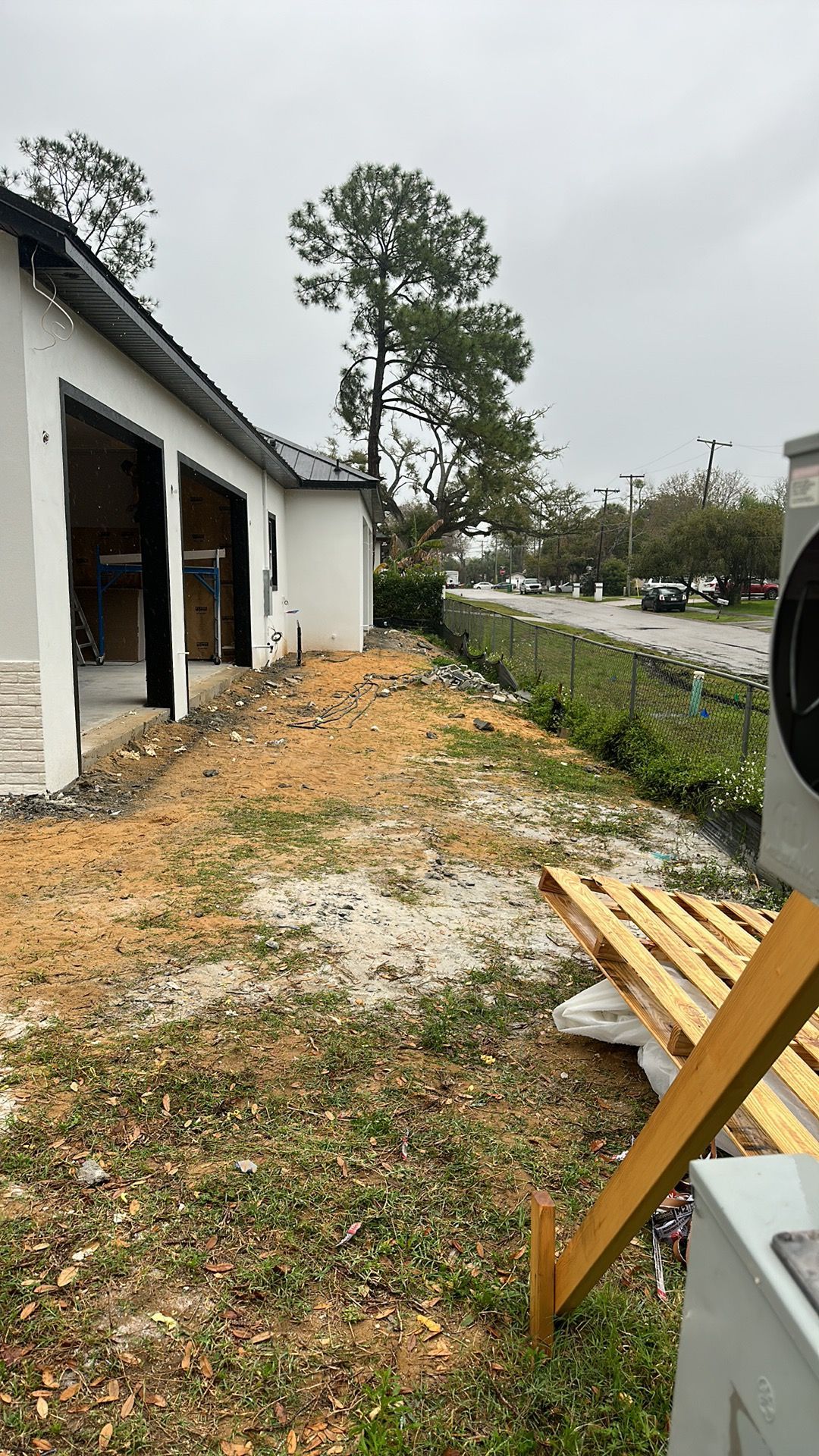 A house is being built in the middle of a grassy field.