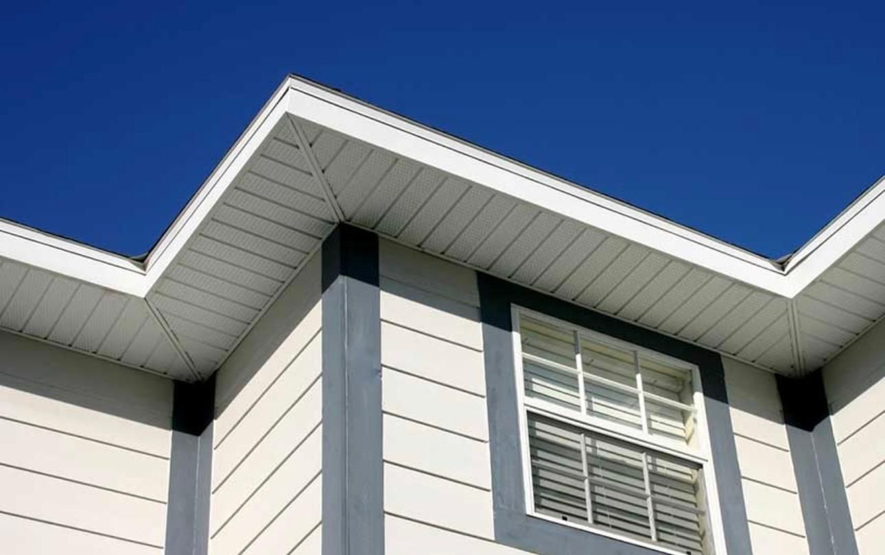 The roof of a house with a blue sky in the background.