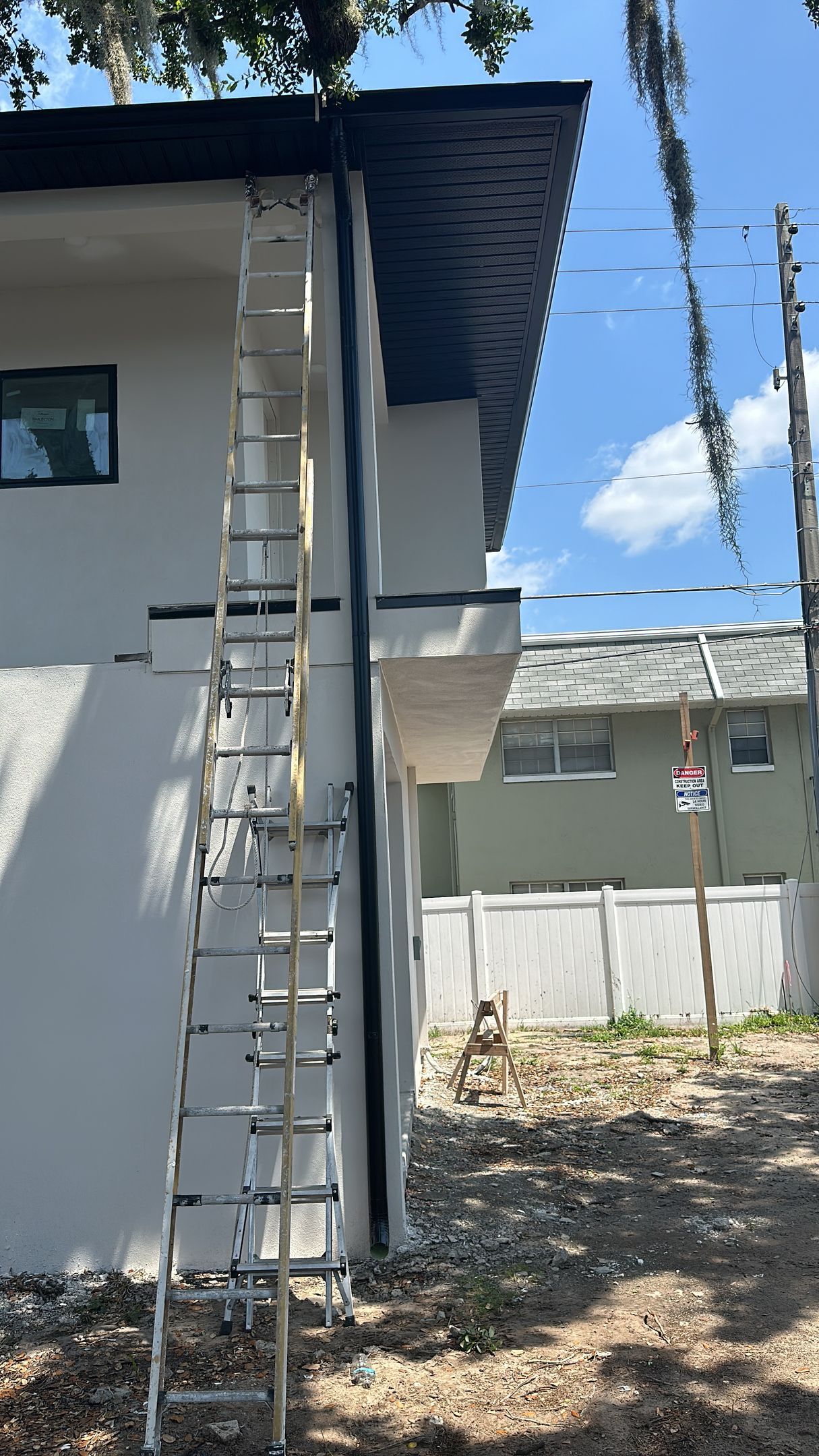 A ladder is attached to the side of a house.