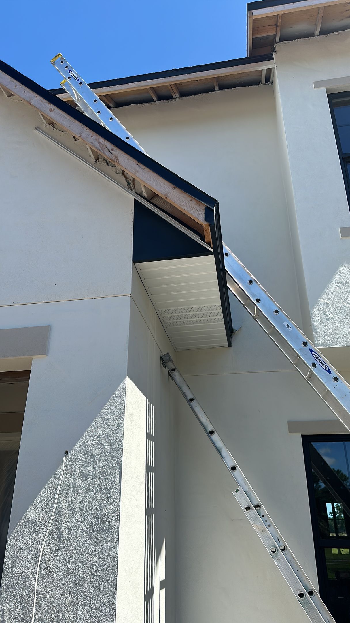 A ladder is hanging from the side of a building.