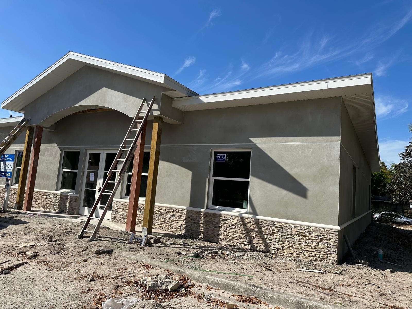 A building under construction with a ladder on the side of it.