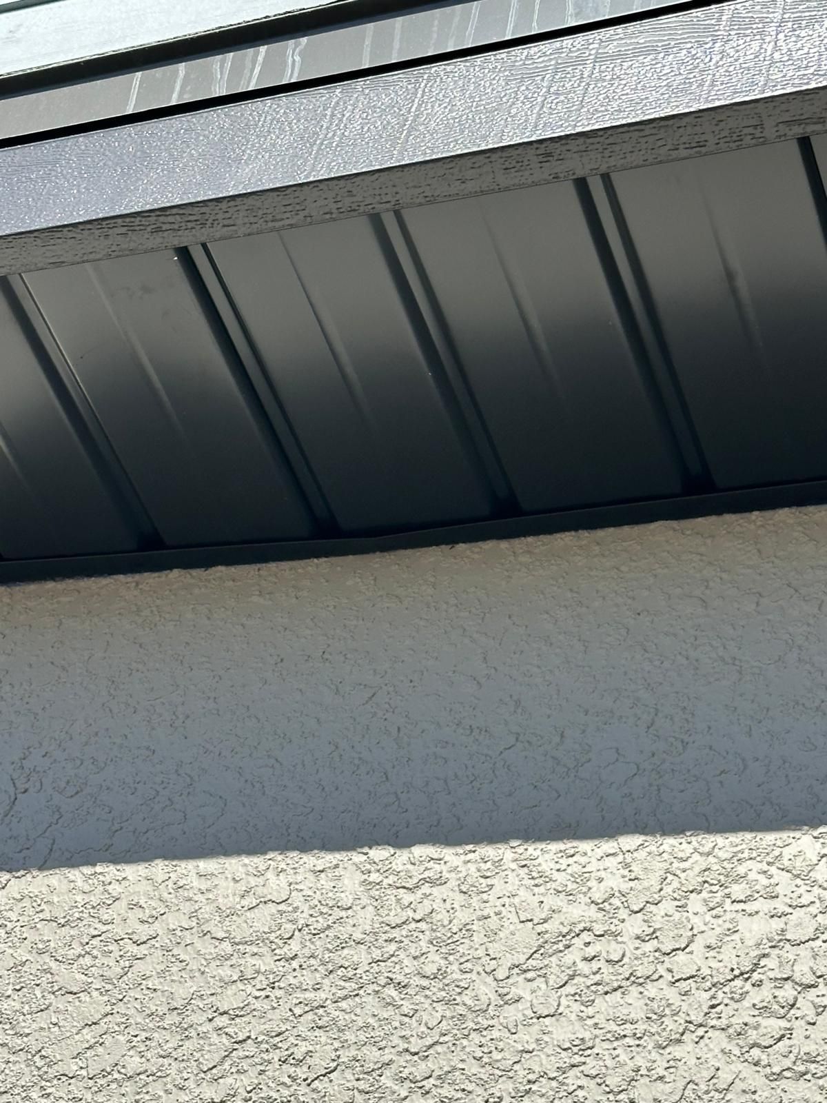 A close up of a black roof on a building.