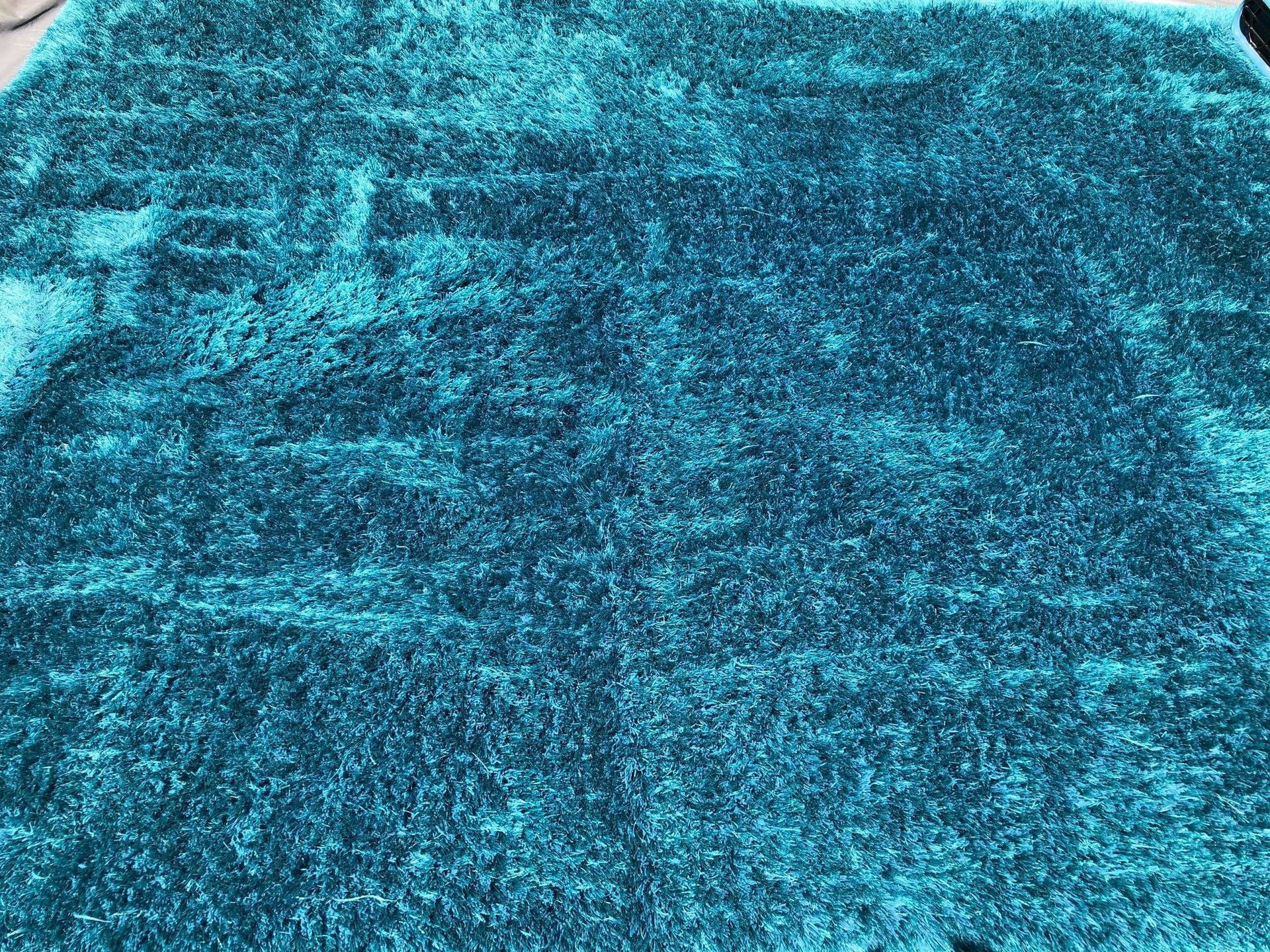 A close up of a blue rug on a table.