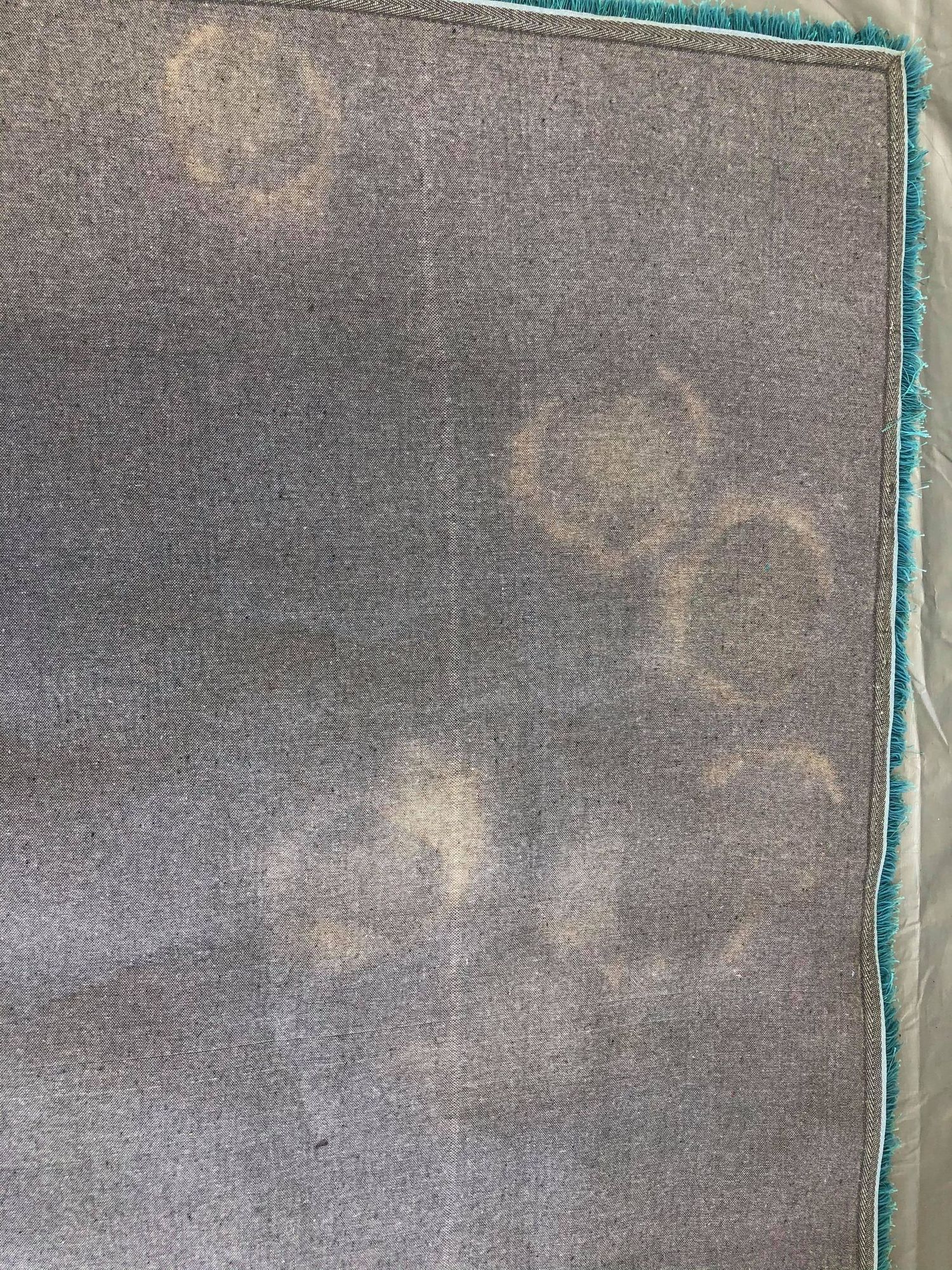 A close up of a dirty rug on a table.