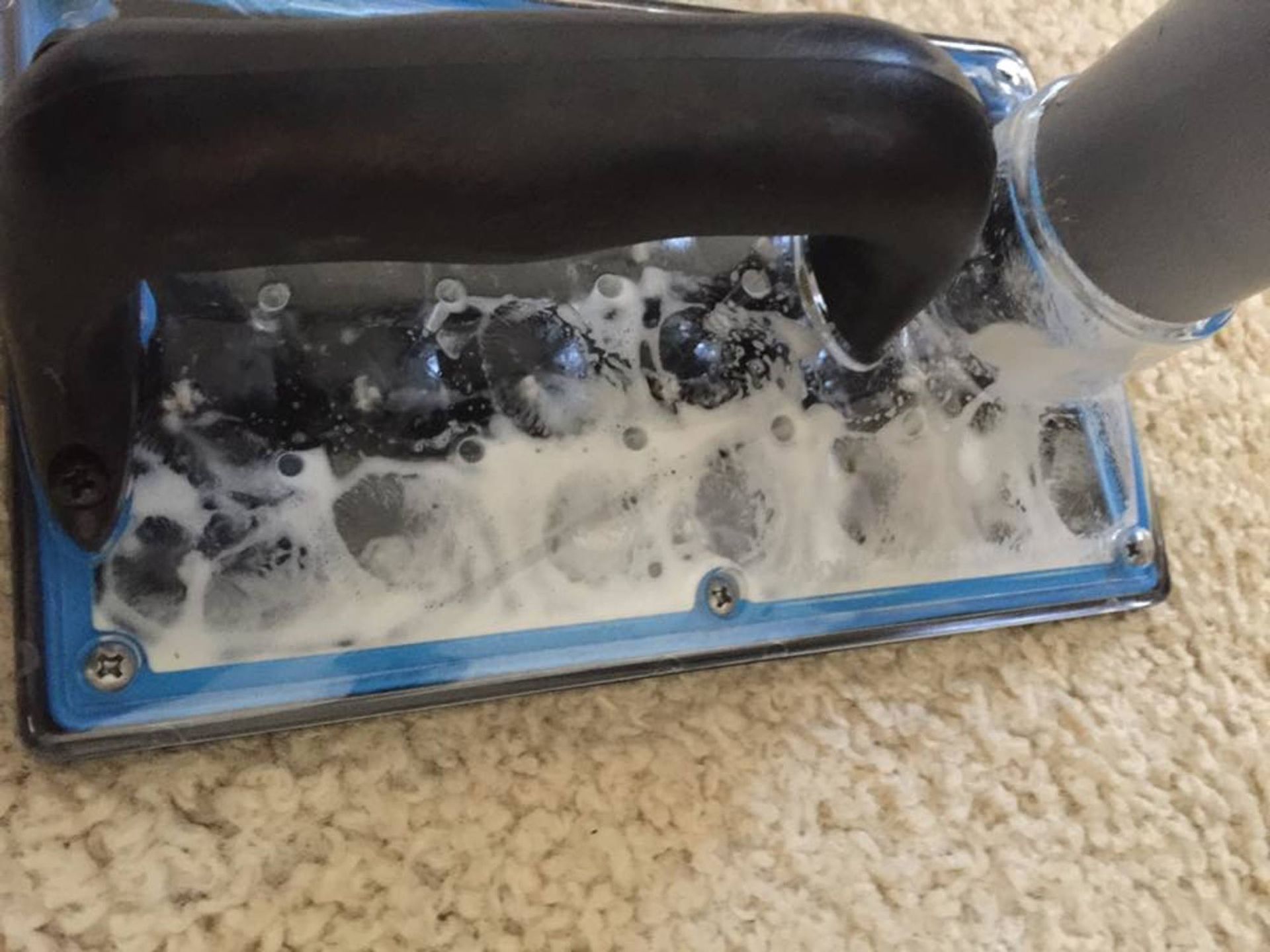 A close up of a vacuum cleaner on a carpet.
