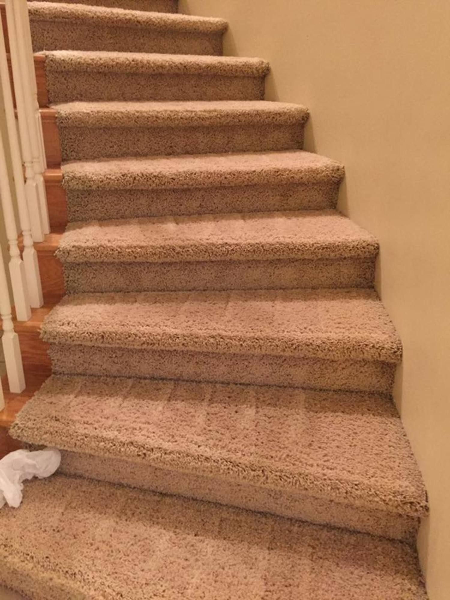 A staircase with carpeted steps and a white railing.