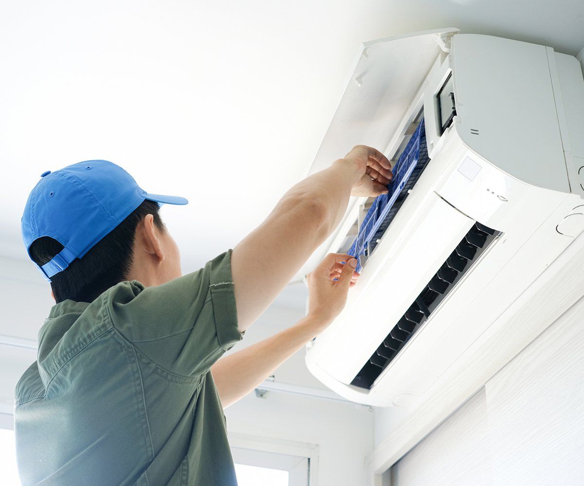 Male Repair Air Conditioner at Room — Westernport, MD — Apex Heating and Cooling Inc