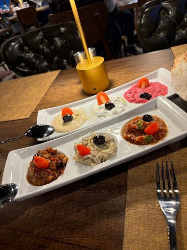 A plate of food with a fork and spoon on a table.