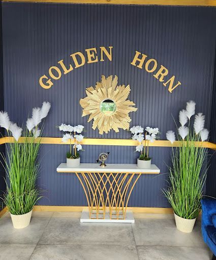 A table in front of a wall that says golden horn