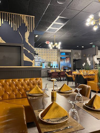 A restaurant with tables and chairs set for a meal.